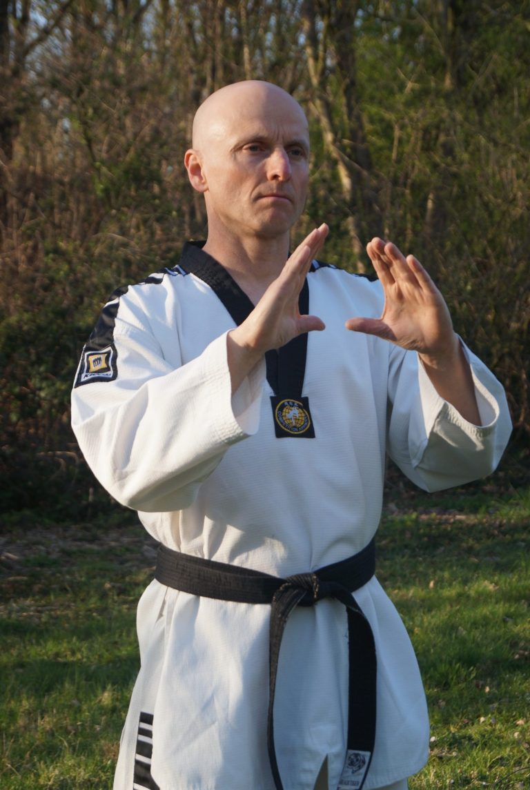 Markus Koschorreck im Taekwondo-Anzug mit schwarzem Kragen und schwarzem Gürtel in fokussierter Grundstellung.